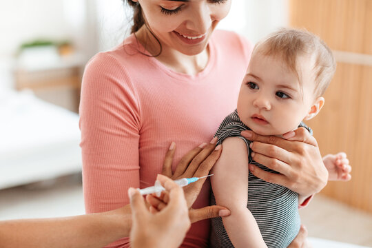 Child receiving vaccination from pediatrician